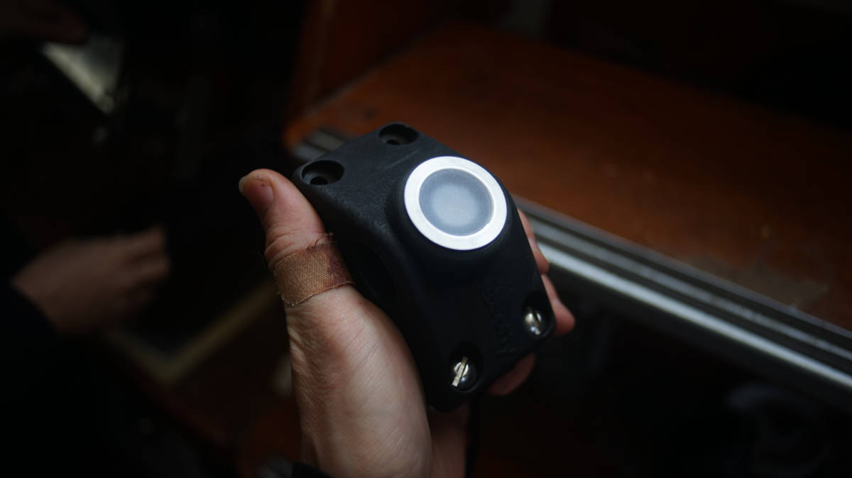 a Scotty fishing rod holder with a potted light wedged into one of the holes