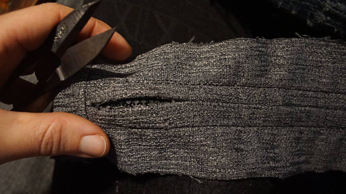 stitches are removed on the other side of the strip to reveal the zipper underneath