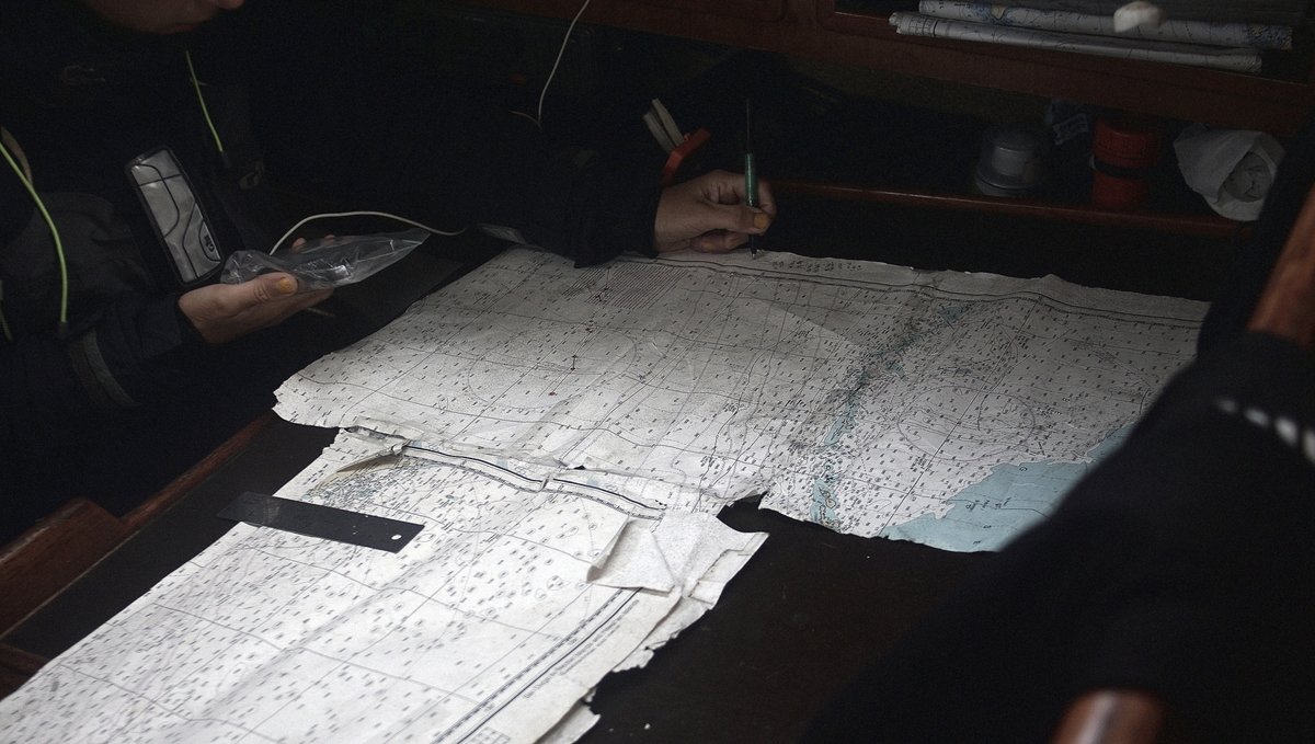 rekka plotting a route on a very decrepit and rotten chart