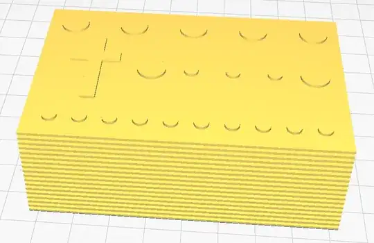 Screenshot of a rectangular 3D model with circles and a cross on top in Cura