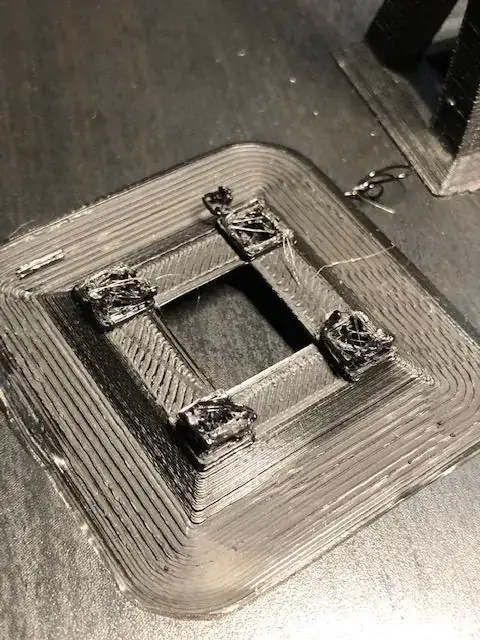 Close-up photo of the base of a printed model with printing errors Close-up photo of the base of a printed model with printing errors