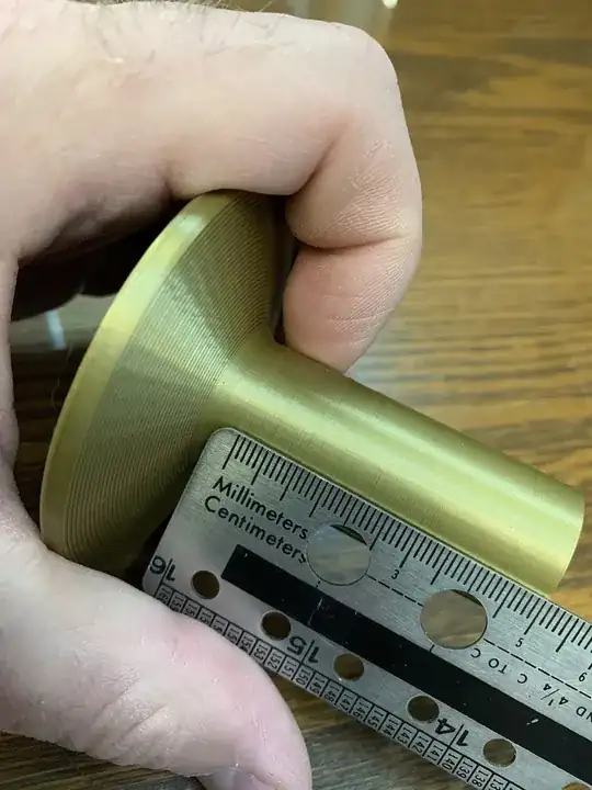 Photo of ruler measuring the evenly spaced horizontal bulges on the base of Christmas tree