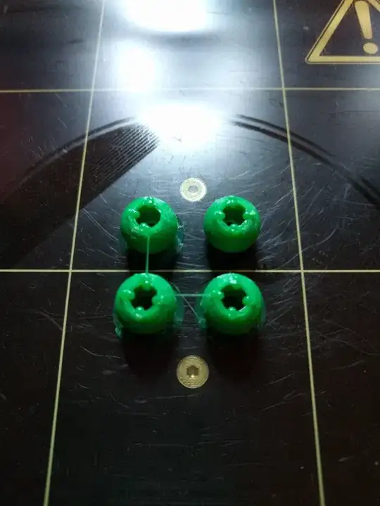 Photo of four balls exhibiting bumps around a cyclindrical through hole