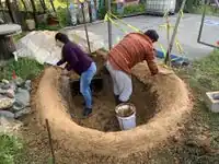 Image 3: A clay slurry was made to smooth out the berm and seal it into place.