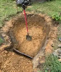 Image 4: Pond was excavated until the bottom of the was flat, and shaped a bit more on the sides and where the retaining wall will go.