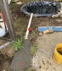 Image 12. Spillway channel with water dispersal gravel field and pipe in place.