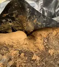 Image 11. Spillway/overflow divit cut into berm to fit spillway pipe.