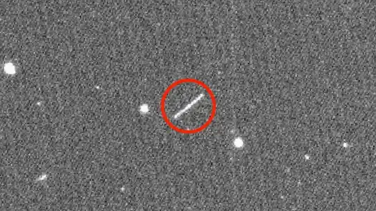 NASA/JPL/ZTF/Caltech Optical Observatories handout image obtained on August 18, 2020 shows asteroid 2020 QG (the circled streak in the center), which came closer to Earth than any other nonimpacting asteroid on record NASA/JPL-CALTECH/AFP