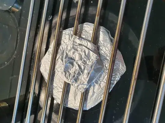 Grill with aluminum placed to reduce heat to hotspots