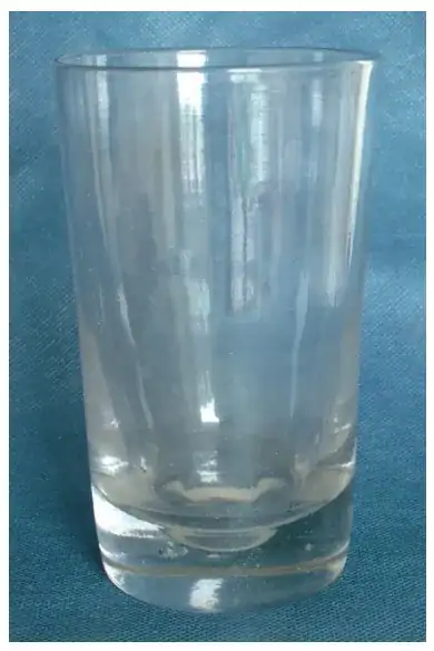 an old straight-edged clear glass with a very thick base