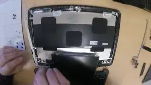 The left hinge is labeled with an "L" within the inside corner. The left hinge is smaller and the hinge bracket is more of a horizontal shape