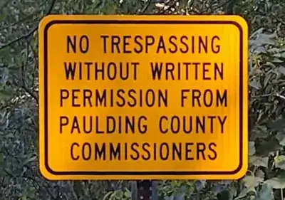 "NO TRESSPASSING WITHOUT WRITTEN PERMISSION FROM PAULDING COUNTY COMISSIONERS"