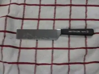 The knife from the question, resting on top of a towel.
