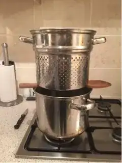 Perforated pan balanced above pan of water