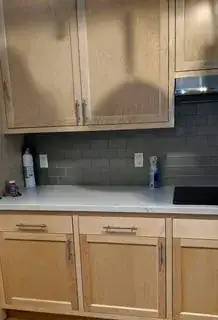 kitchen counter with cabinets above and below