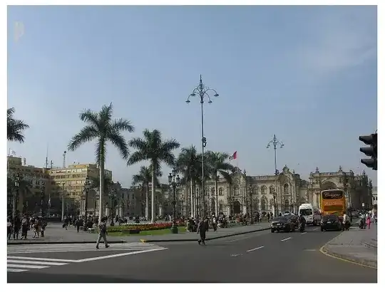 Picture of a city square lined with palm trees.