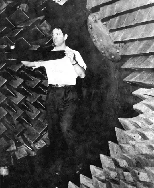 Vincent Benedetti placing a submarine model inside the large anechoic tank at the Naval Research Laboratory - Orlando, Florida.