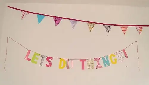 festive letters suspended from a string read "LETS DO THINGS!"