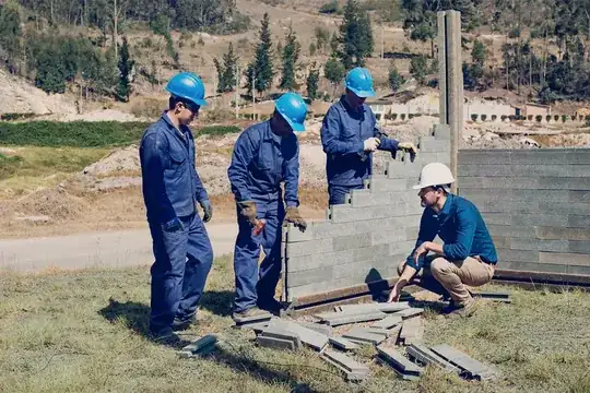 Building a house with bricks made from recycled plastic