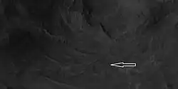 Close view of central section of Auki showing ridges with arrow Image is an enlargement of a previous HiRISE image.