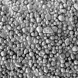 Figure 19. Small, loose hematite spherules on soils about 500 m northwest of Victoria Crater. In this image, most spherules have 1 - 2 mm diameters. A few have diameters under 1 mm, and the largest is 2.5 mm x 4 mm. Image taken on Sol 910 (2004-08-15).