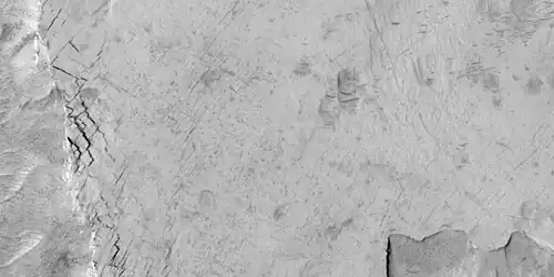 Close-up of blocks being formed, as seen by HiRISE under HiWish program.  Many long fractures are visible on the surface.