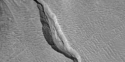 Close view of channel in gully showing streamlined forms,  as seen by HiRISE under HiWish program