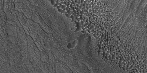 Close view of contact, as seen by HiRISE under HiWish program  Picture shows details of how upper plains material is breaking.  The formation of many fractures seems to proceed the break up.