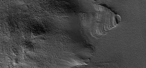 Close view of exhumed crater, as seen by HiRISE under HiWish program.  This crater is and was under a set of dipping layers.