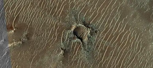 Crater with colorful ejecta, as seen by HiRISE under the HiWish program  The ejecta represents samples of material from underground.  Craters allow us to study underlying material.