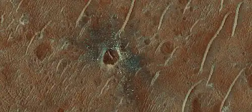 Crater with colorful ejecta, as seen by HiRISE The ejecta represents samples of material from underground.  Craters allow us to study underlying material.