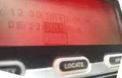 A red-backlit LCD screen above three labelled rubber buttons shows a dropdown selector for dates.