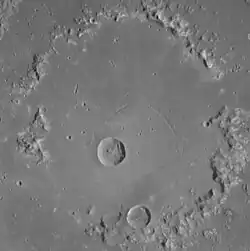 Central peak ring.  Concentric troughs are visible.