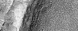 High-center polygons, as seen by HiRISE under HiWish program  Image is of the top of a debris apron in Deuteronilus Mensae.