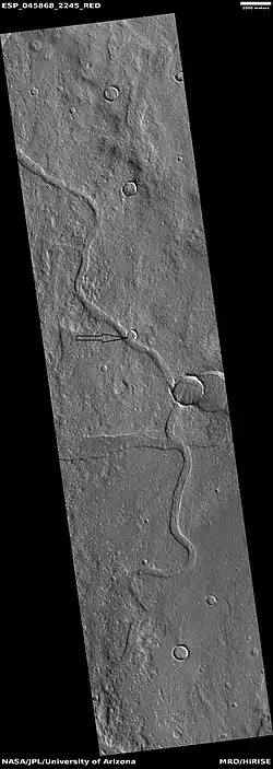 Channel, as seen by HiRISE under HiWish program.  Arrow points to a crater that was probably eroded by flowing water.