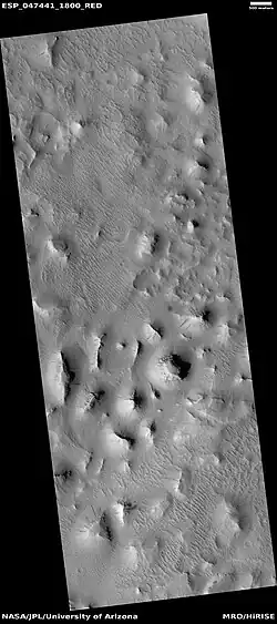 Wide view of layered buttes and small mesas, as seen by HiRISE under HiWish program. Some dark slope streaks are visible.  Location is Aeolis quadrangle.  Parts of this image are enlarged in next three pictures.