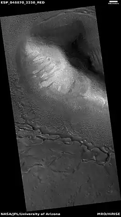 Wide view of upper plains unit eroding into hollows, as seen by HiRISE under HiWish program  Parts of this image are enlarged in following images.