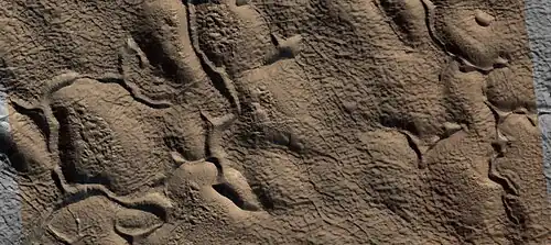 Close view of upper plains unit showing hollows--where ice left the ground.  Picture is about 1 Km across.  This is part of an image named HiRISE picture of the day for October 21, 2024.