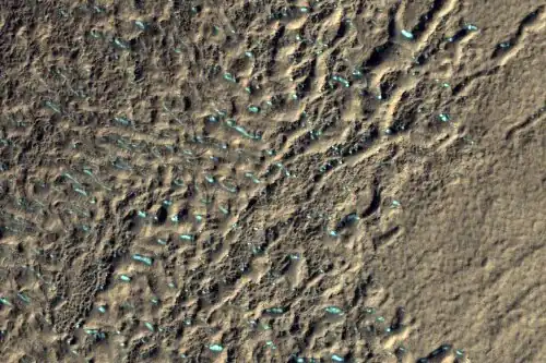 Surface of debris apron in Terra Cimmeria, as seen by HiRISE, under the HiWish program.  Colored parts may be frost deposits.