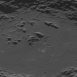 Oblique view of the central crater.  Some of the irregular, bright depressions are hollows.