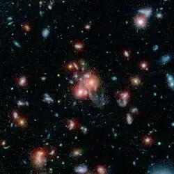 Galaxy cluster SpARCS1049 taken by Spitzer and the Hubble Space Telescope.