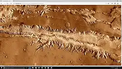 Wide view of part of Ius Chasma with the Louros Valles along its southern margin.