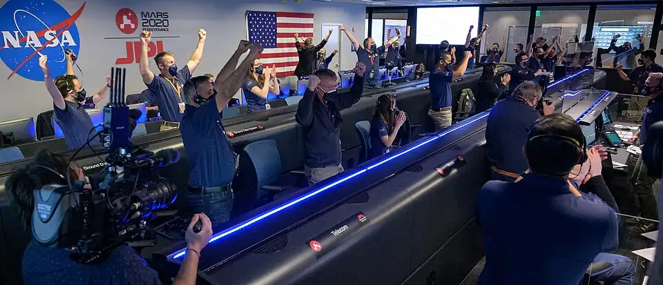JPL employees celebrate the landing of the Perseverance rover in JPL's mission control.