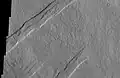 Oti Fossae, as seen by THEMIS.  These parallel graben are found on the northeastern side of Arsia Mons; they are in line with the NE/SW trend of the three volcanoes in Tharsis.