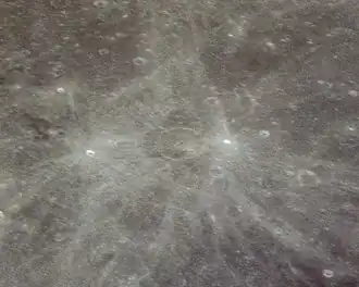 Oblique regional view with Stevinus at center, and two small bright craters with prominent ray systems: Stevinus A at right and Furnerius A at left. From Apollo 13.