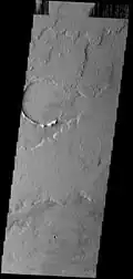 THEMIS image of lava flow plains northeast of Tharsis Tholus. The volcano is surrounded by these Amazonian-aged lava flows from the interior of the Tharsis region to the west.