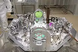 Intricate optics, with a person nearby for scale