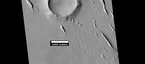 Yardangs near a crater in Amazonis, in the middle of the region