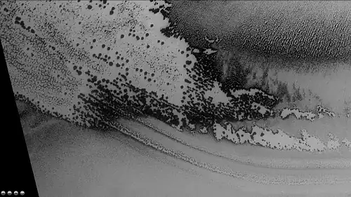 Defrosting going on in Playfair crater, as seen by CTX camera (on Mars Reconnaissance Orbiter).  Dark areas are where frost has disappeared thereby showing dark ground.  Note: this is an enlargement of the previous image of Playfair crater.