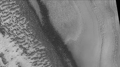 Reynolds crater showing layers and dark spots from defrosting, as seen by CTX camera (on Mars Reconnaissance Orbiter).  Area is covered by frost, when the frost disappears the underlying dark ground is exposed.  Layers are also visible.  Note: this is an enlargement of a previous image of Reynolds crater.
